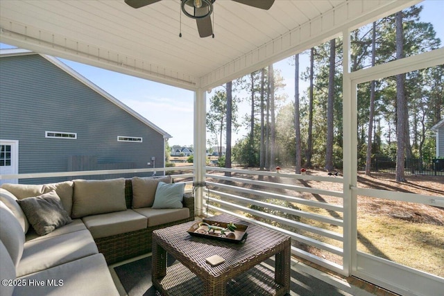 sunroom / solarium featuring a ceiling fan