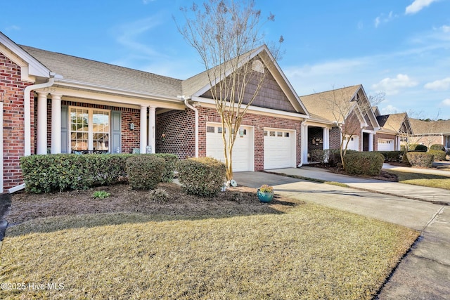 ranch-style house with a front lawn, roof with shingles, concrete driveway, an attached garage, and brick siding