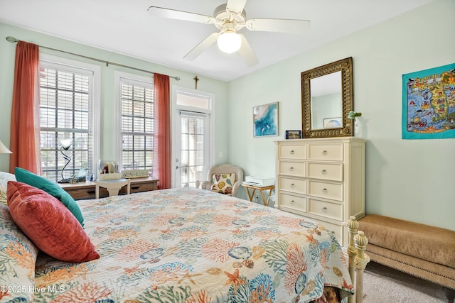 bedroom featuring access to exterior, multiple windows, and a ceiling fan