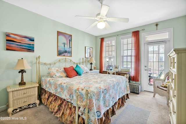 carpeted bedroom featuring ceiling fan and access to exterior