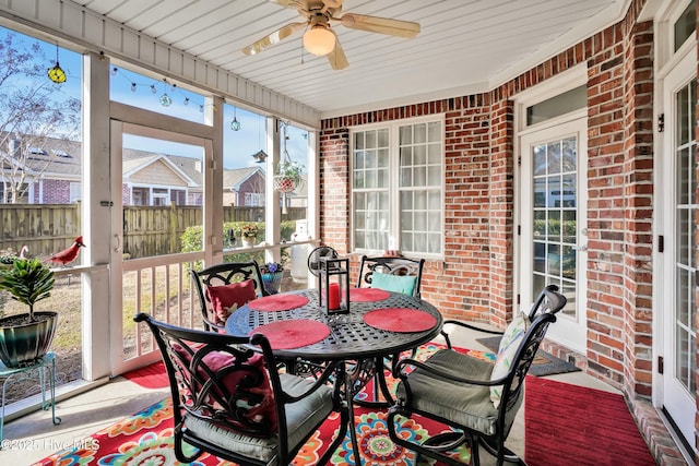 sunroom featuring a ceiling fan