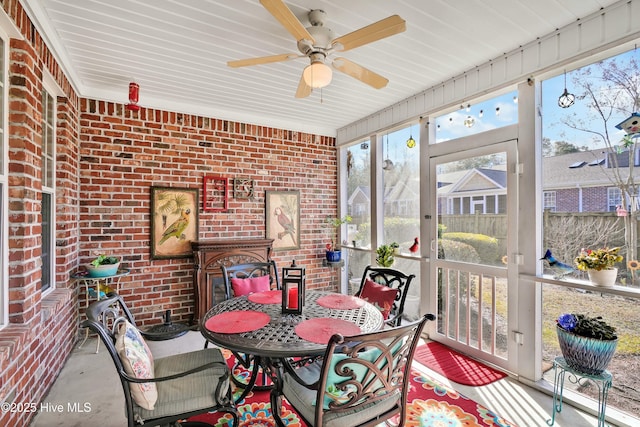 sunroom featuring a ceiling fan