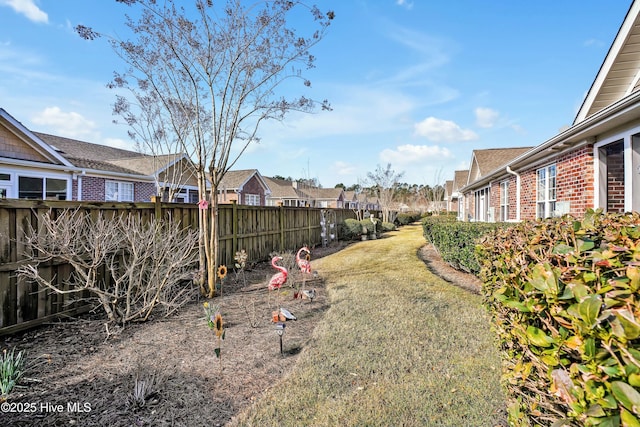 view of yard with a residential view and fence