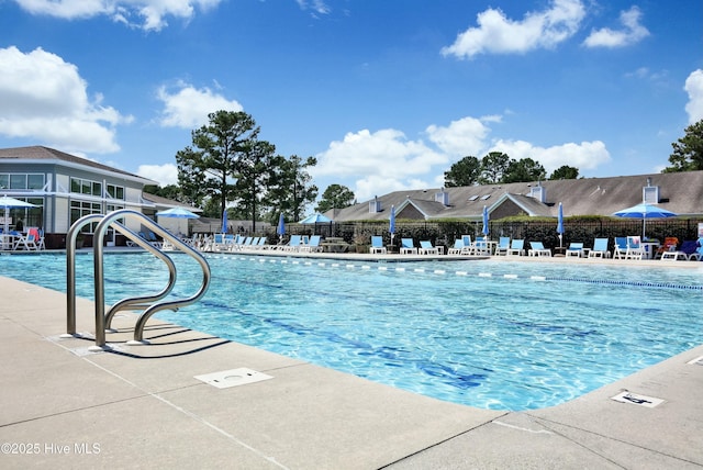 community pool featuring a patio and fence