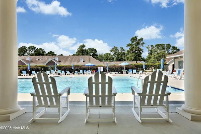 pool with fence and a patio area