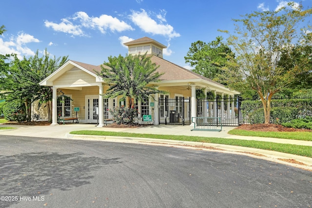 view of front facade with french doors and fence