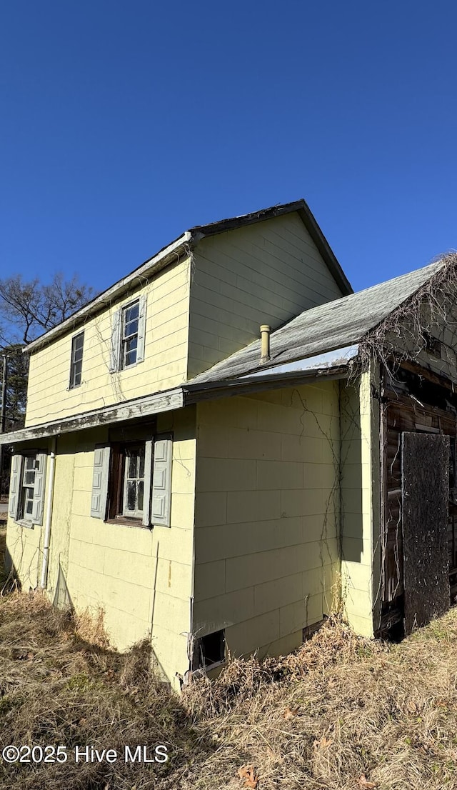 view of home's exterior with concrete block siding