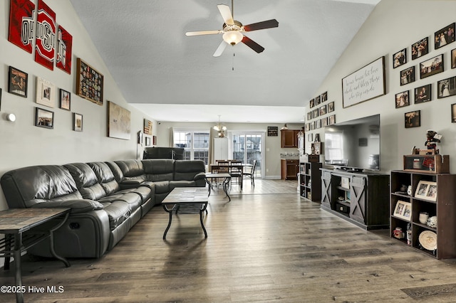 living area featuring ceiling fan, baseboards, high vaulted ceiling, and wood finished floors