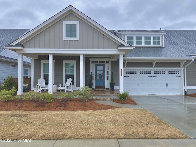 view of front of home with board and batten siding, concrete driveway, a garage, and covered porch