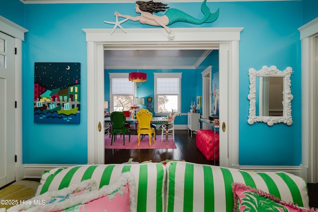 bedroom with wood finished floors and crown molding