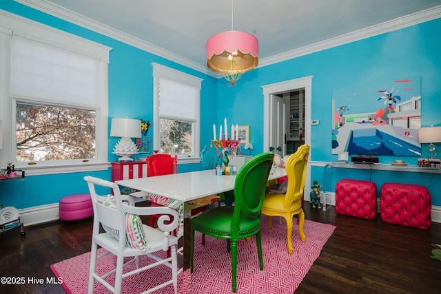 dining room with wood finished floors and ornamental molding