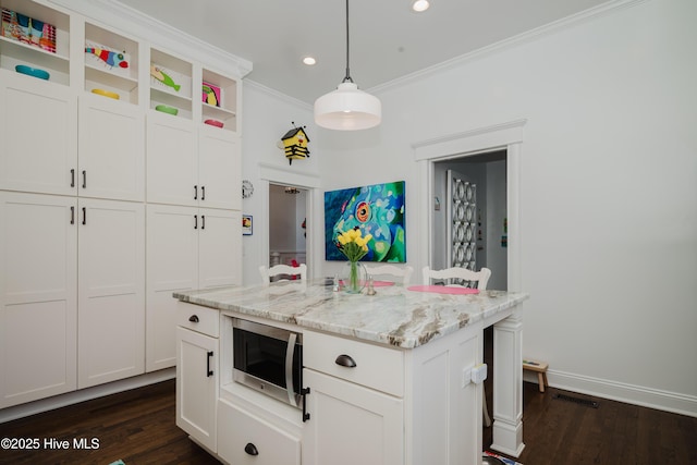 kitchen with open shelves, stainless steel microwave, dark wood-style floors, and ornamental molding