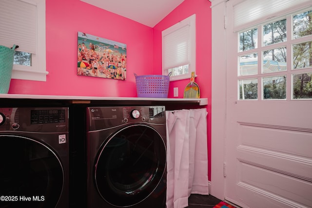 washroom with washing machine and dryer and laundry area