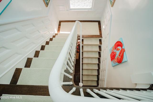 staircase with a decorative wall