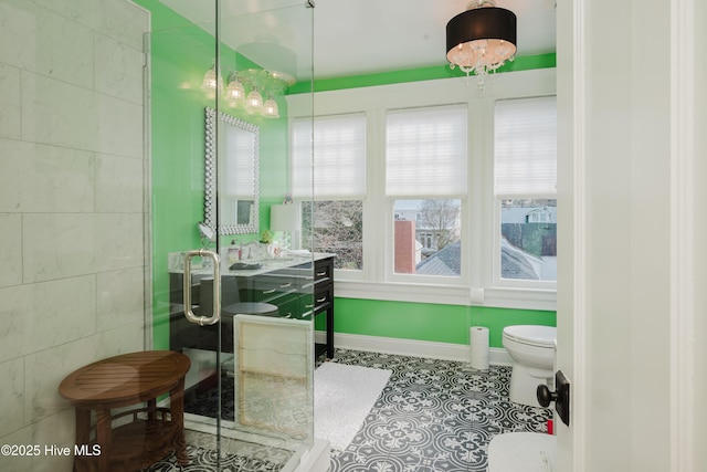 full bathroom with tile patterned flooring, a shower stall, baseboards, toilet, and vanity