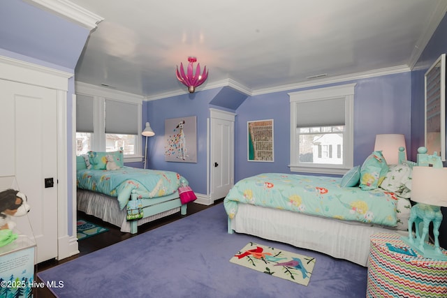 bedroom featuring crown molding, multiple windows, and visible vents