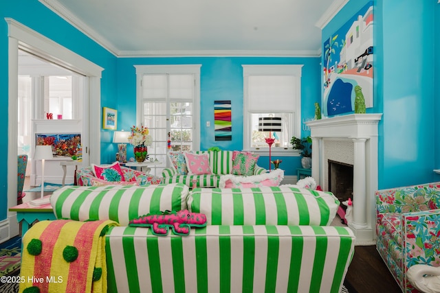 bedroom featuring a fireplace, wood finished floors, and ornamental molding