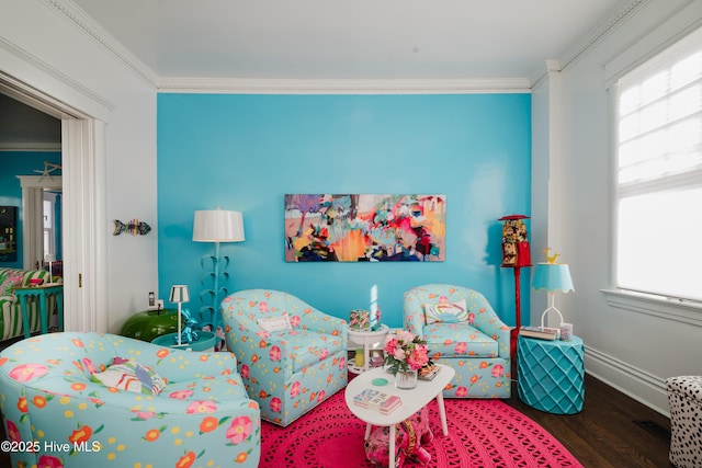 interior space featuring baseboards, wood finished floors, and crown molding