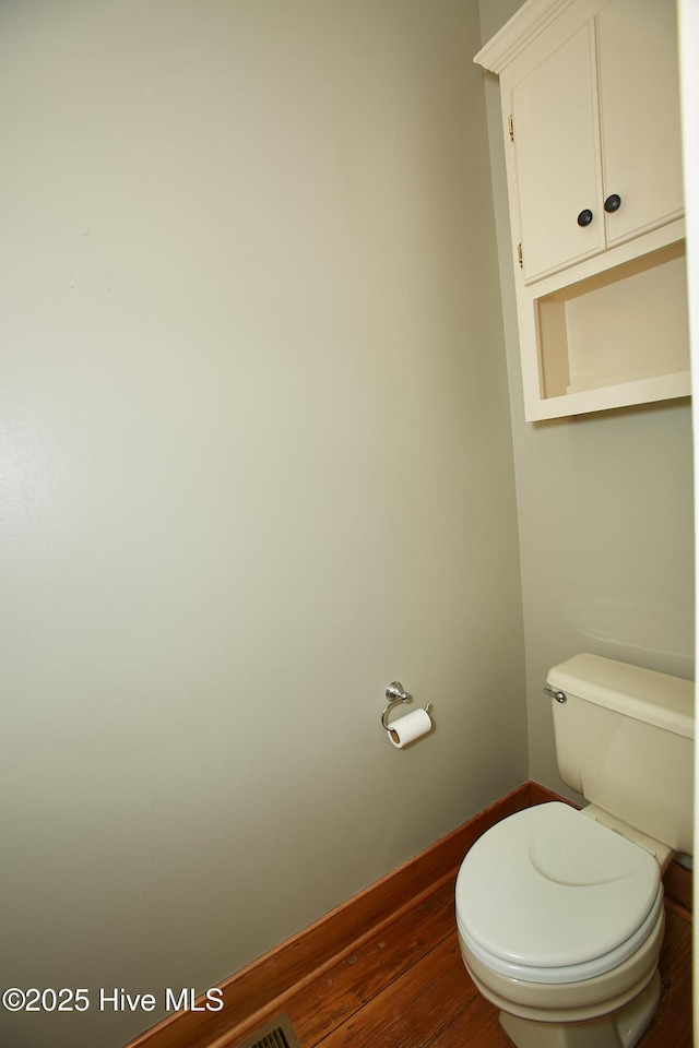 bathroom featuring toilet and wood finished floors