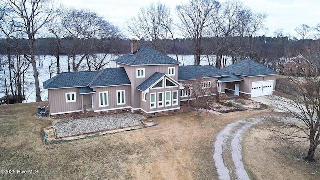 view of front of house with roof with shingles, driveway, a chimney, a garage, and crawl space