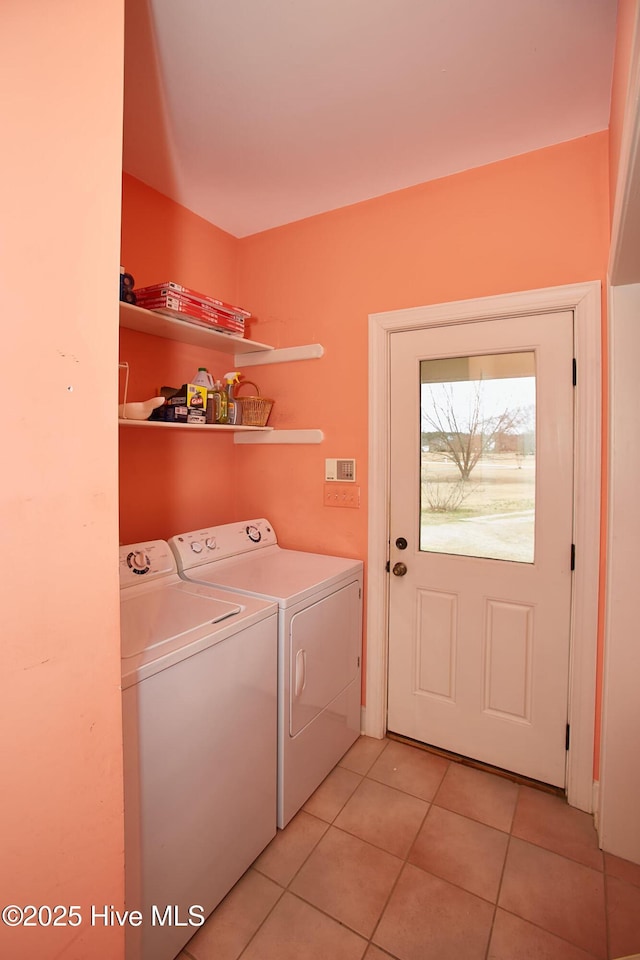 washroom with light tile patterned floors, laundry area, and separate washer and dryer