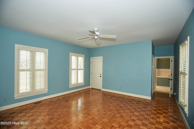 unfurnished bedroom featuring a ceiling fan, baseboards, and visible vents