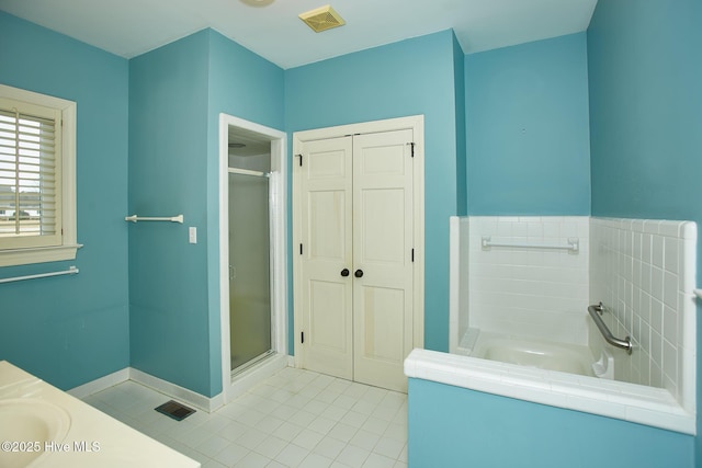 bathroom with tile patterned flooring, a garden tub, visible vents, and a stall shower