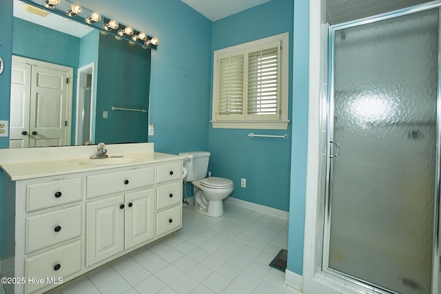 bathroom with a shower stall, baseboards, toilet, tile patterned floors, and vanity