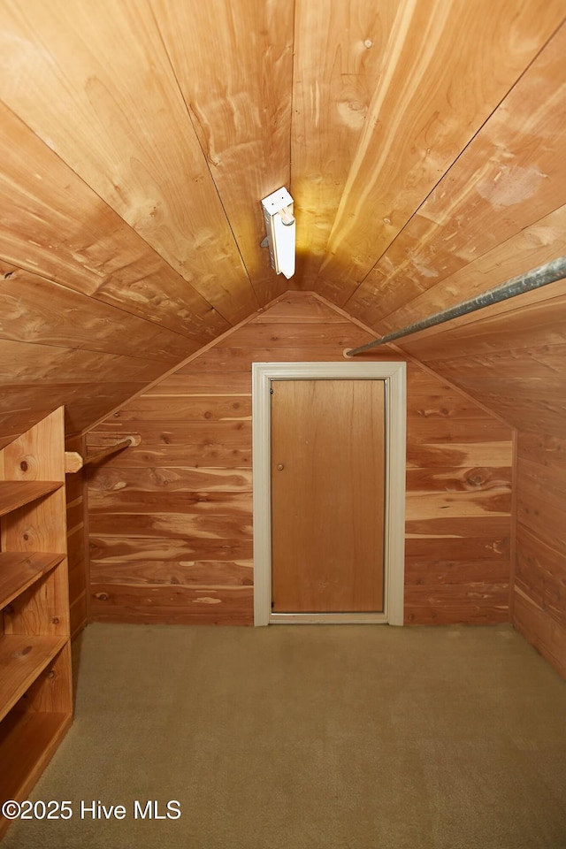 additional living space featuring wood walls, wood ceiling, carpet, and vaulted ceiling