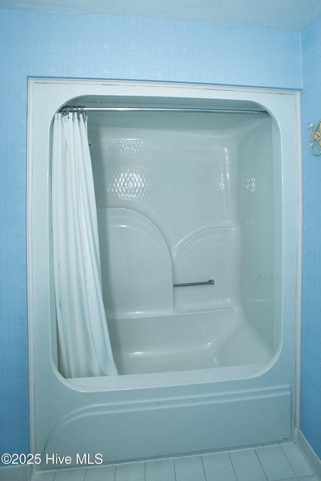 interior details with a bathing tub and curtained shower