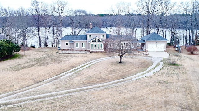 birds eye view of property featuring a wooded view