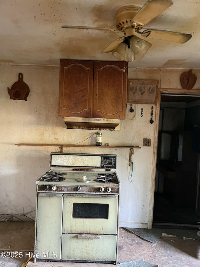 kitchen featuring under cabinet range hood, gas stove, and ceiling fan