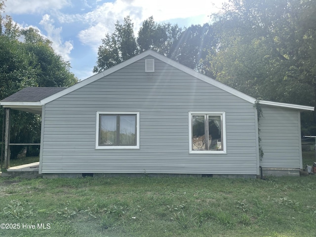 view of property exterior featuring crawl space and a lawn