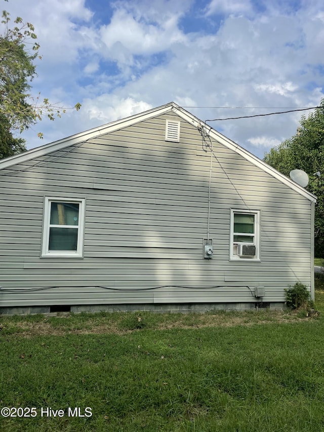 view of side of property with a yard and cooling unit