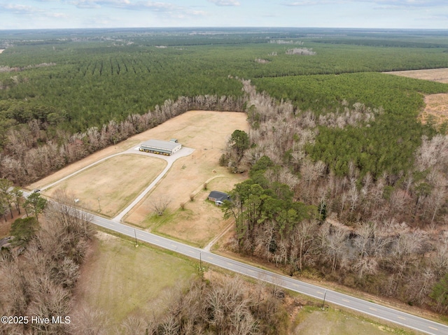 aerial view featuring a rural view and a wooded view