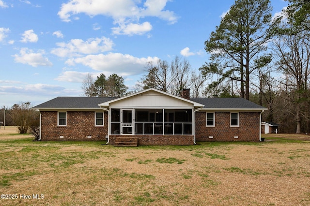 rear view of property with a yard, a chimney, a sunroom, and crawl space