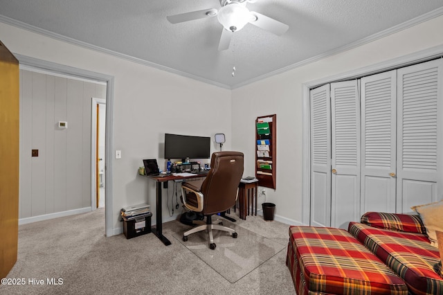 carpeted office featuring a ceiling fan, baseboards, a textured ceiling, and crown molding