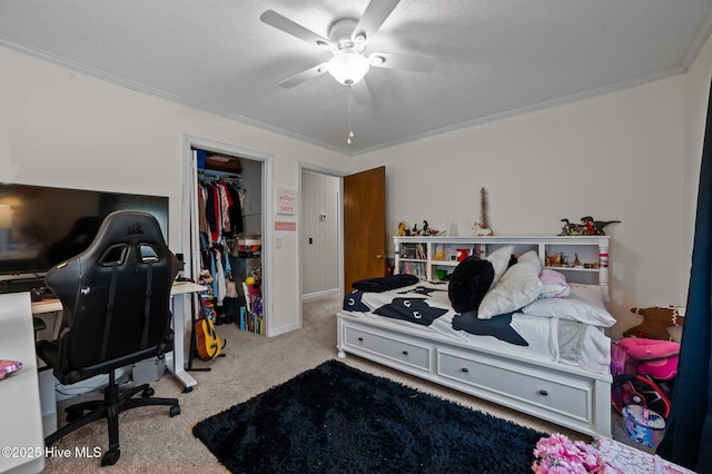 carpeted bedroom featuring a textured ceiling, crown molding, and a ceiling fan