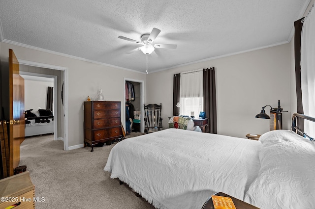 bedroom featuring a textured ceiling, ornamental molding, ceiling fan, and light carpet