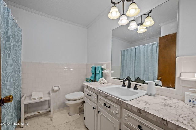 bathroom featuring toilet, ornamental molding, wainscoting, a notable chandelier, and tile walls