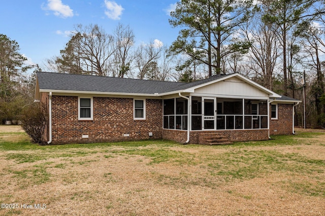 back of house featuring a yard, a sunroom, a shingled roof, crawl space, and brick siding