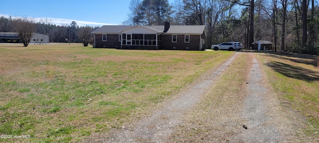 ranch-style home featuring crawl space, driveway, a front yard, and brick siding