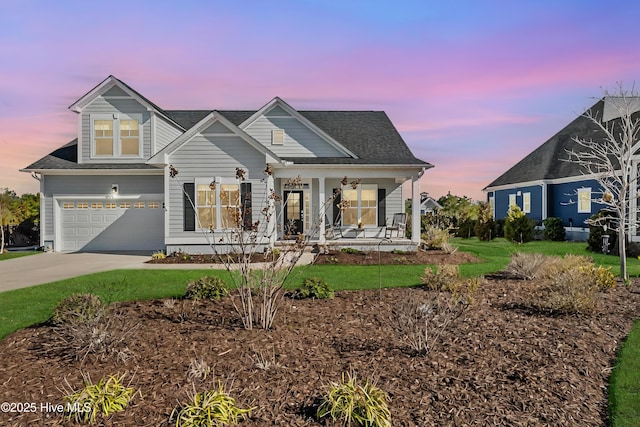 view of front of house featuring a porch, a garage, and driveway