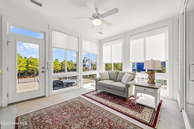 sunroom / solarium featuring visible vents and ceiling fan