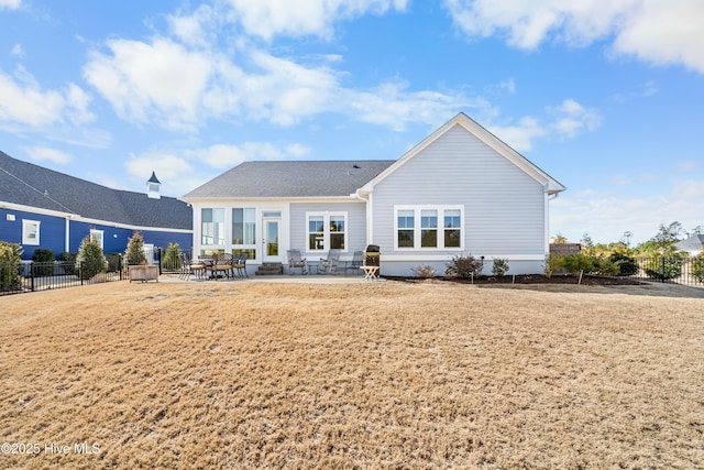 back of property featuring a patio area and fence