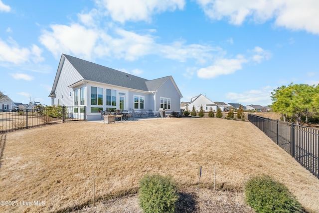 rear view of house featuring a patio and a fenced backyard