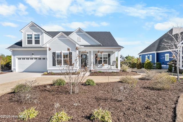 view of front of property featuring a porch, concrete driveway, and an attached garage