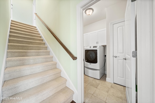 stairs featuring tile patterned floors and washer / dryer