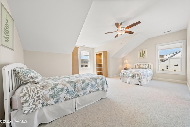 bedroom featuring vaulted ceiling, carpet, visible vents, and ceiling fan