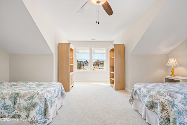 carpeted bedroom featuring baseboards, lofted ceiling, and ceiling fan